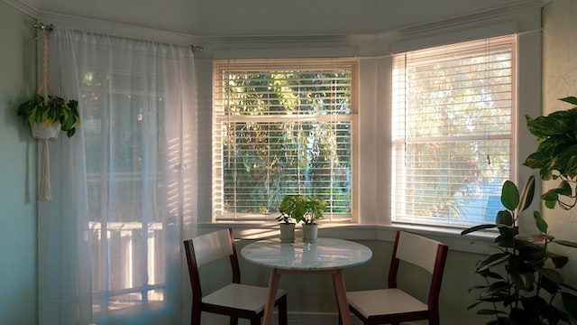 white shades near dining room