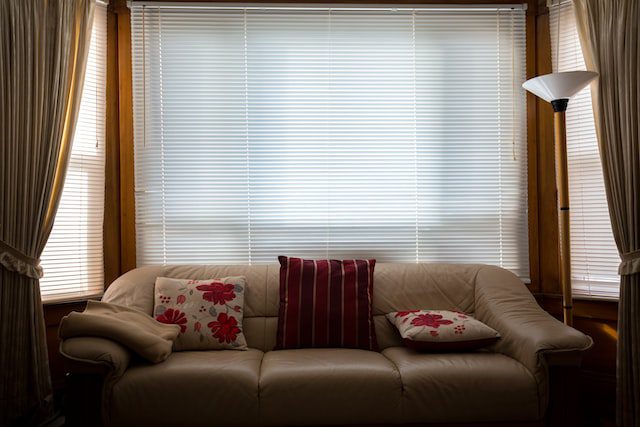 illuminated closed blind above sofa bed in a living room