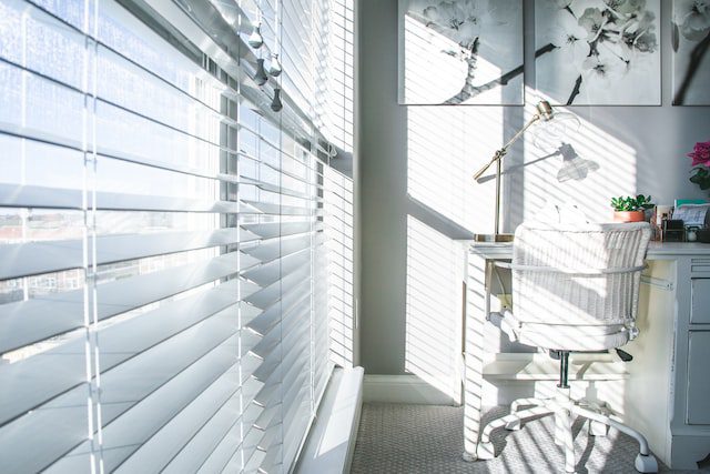 White blinds in white room